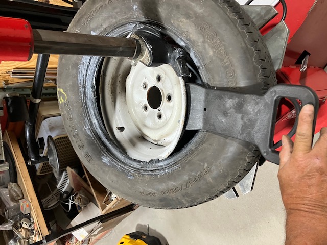 Zeppa tool inserted to force tire bead into the wheel drop center.